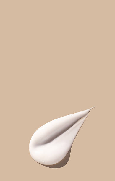 istock sample smear of creamy white texture on light beige background 2221616893