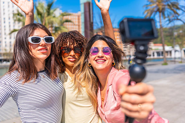 istock Young women taking a selfie while walking in the city 2221617293