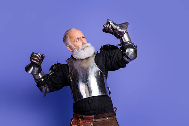 istock Confident knight in shining armor showing determination against a vibrant violet backdrop 2221618459