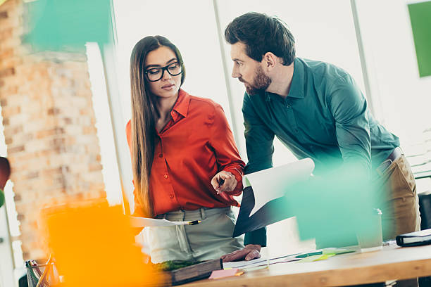 istock Professional teamwork collaboration between a man and woman in an office discussing and strategizing with documents 2221619379
