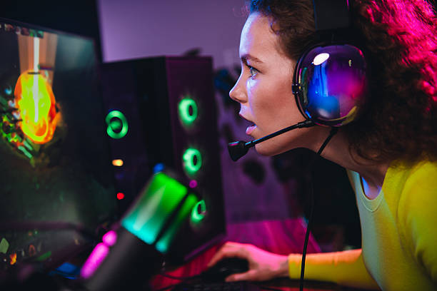 istock Young surprised female gamer streaming a video game at night, computer theme 2221620436