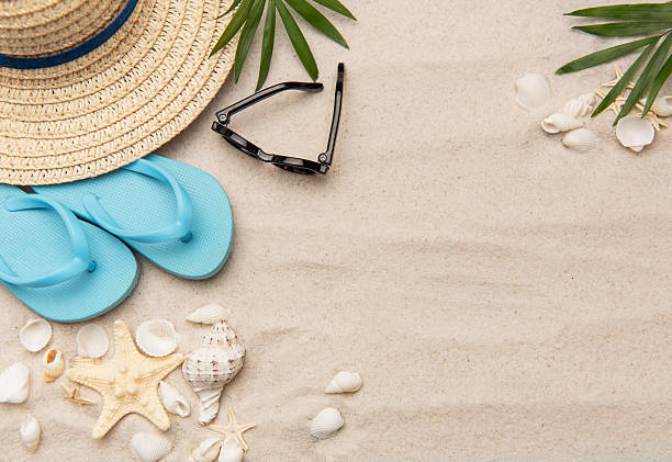 istock Beach accessories lying on sand creating summer vacation background 2221626992