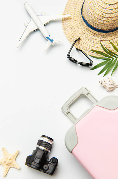 istock Pink suitcase, camera, sunglasses and airplane model suggesting summer vacation planning 2221626995