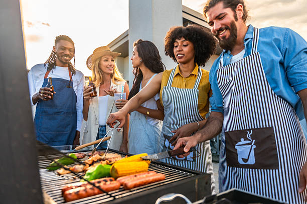 istock Chefs grilling meat and vegetables for a rooftop barbecue party 2221627537