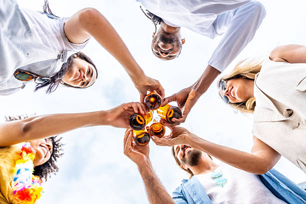 istock Friends toasting with beer bottles at a summer party 2221628207