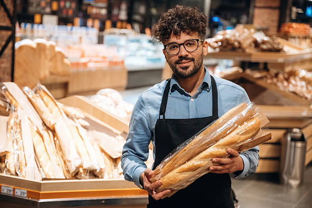 istock Fresh bakery. Male worker is in the grocery store 2221628673
