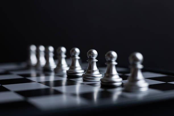istock silver pawn chess on dark background 2221628859