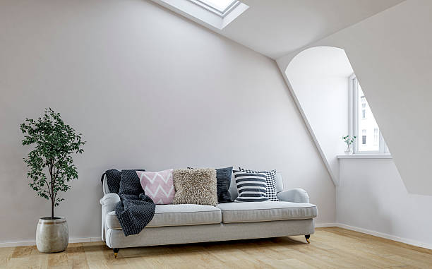 istock Bright Scandinavian Loft Interior with Roof windows (skylight), sloped ceiling, Cozy Sofa and Decorative Cushions 2221631487