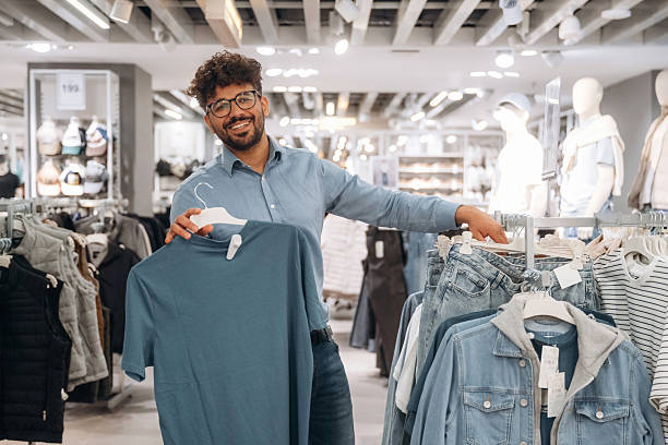 istock Section with jackets. Man customer is in the clothing store 2221632554