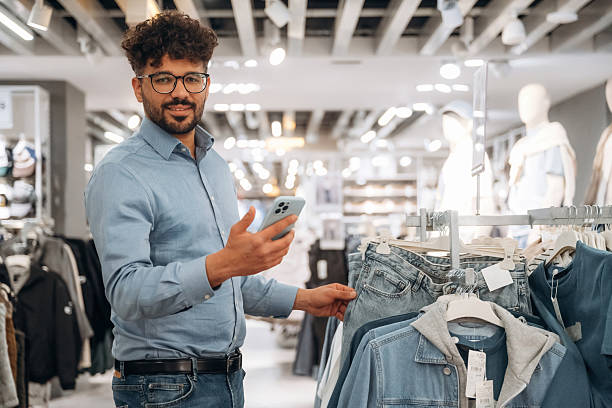 istock Section with jackets. Man customer is in the clothing store 2221632651