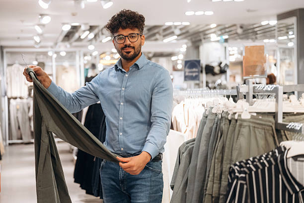 istock Man customer is in the clothing store 2221632675