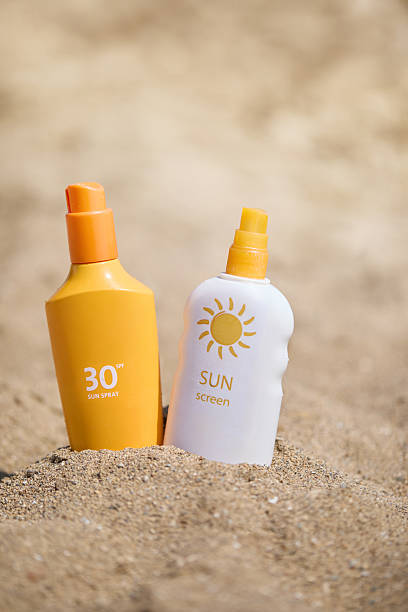 istock Sunscreen bottles with SPF  placed on sandy beach, emphasizing skincare during sunny summer. Concept of sun protection and outdoor leisure. 2221634121