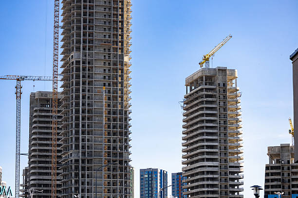 istock Construction crane on Housing. Construction site with buildings under construction. Tower cranes in action. Crane during formworks. Multi Storey Residential Buildings construction. 2221635016