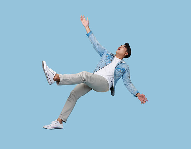 istock excited asian man relaxing floating in mid-air isolated on blue copy space background. 2221636158