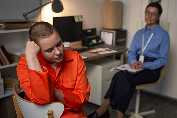 istock Young Caucasian Woman in Prison Uniform Sitting in Office Feeling Distressed 2221637178