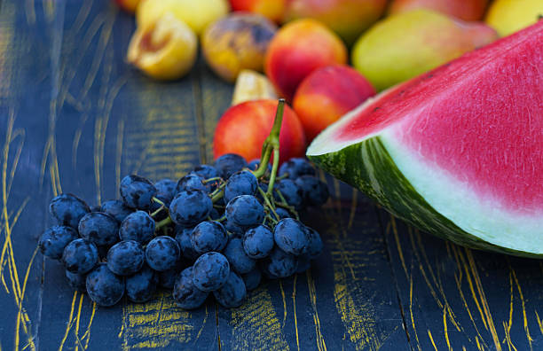 Grapes and various fruits are spread on the board