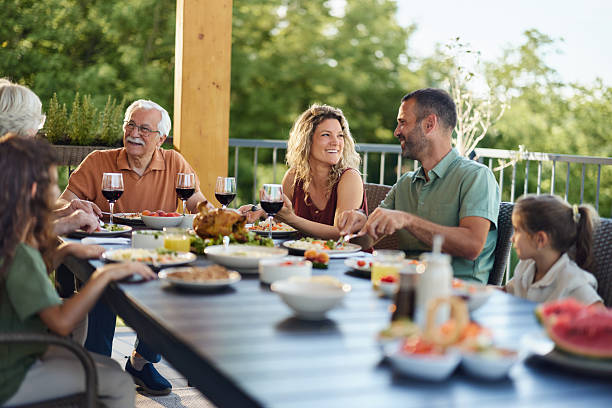 istock Happy extended family enjoying in conversation during a meal on a terrace. 2221638310