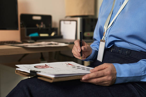 istock Middle Aged Caucasian Woman Reviewing Prisoner Identification Documents 2221639242