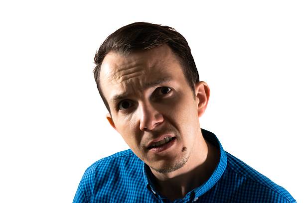 Adult male with puzzled expression, raised brow and direct eye contact, typically portraying confusion or need for clarification in professional or casual situations
