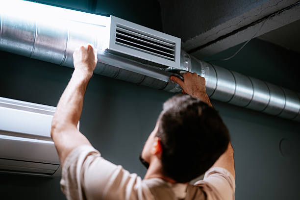 istock Technician repairing air duct system in modern interior during daytime 2221642224