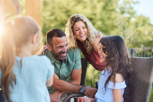 istock Happy parents talking to their daughters on a terrace. 2221642363
