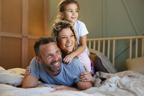 istock Happy family making human pyramid on a bed. 2221642445