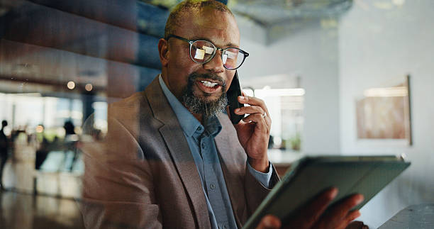 istock Phone call, planning and tablet with business black man in office for communication or update. App, conversation and strategy with mature employee in workplace for accounting or finance feedback 2221643532