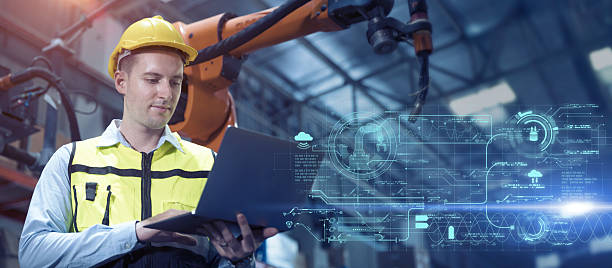 istock professional engineer, advance technology in modern factory industry control operate robot welding arm machine with laptop program software 2221643853