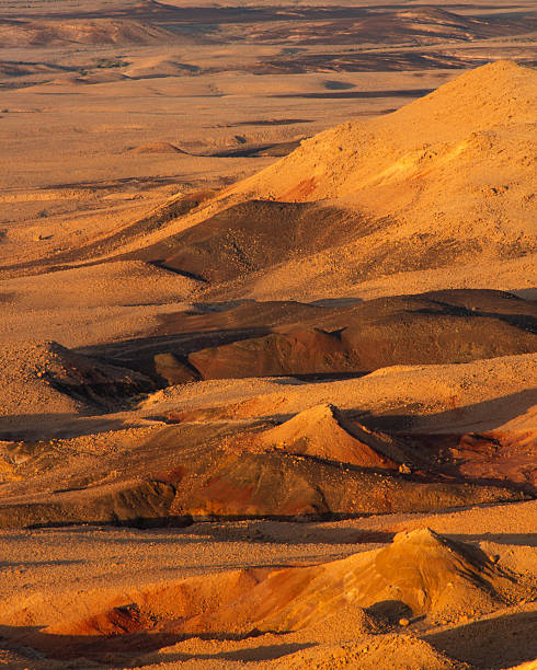 The rugged terrain of Ramon Crater (Makhtesh Ramon) at sunrise in the Negev desert of southern Israel