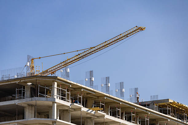 istock Construction of a multi-storey apartment building. Construction site. Construction in progress and concrete house frame. Construction site with buildings under construction. Tower cranes in action. 2221645144