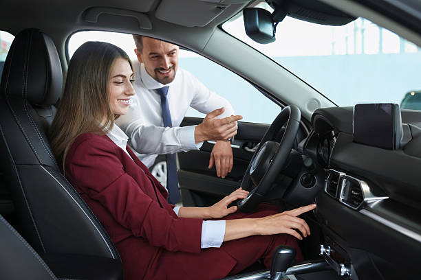 istock Happy salesman and client inside new car in salon 2221645783
