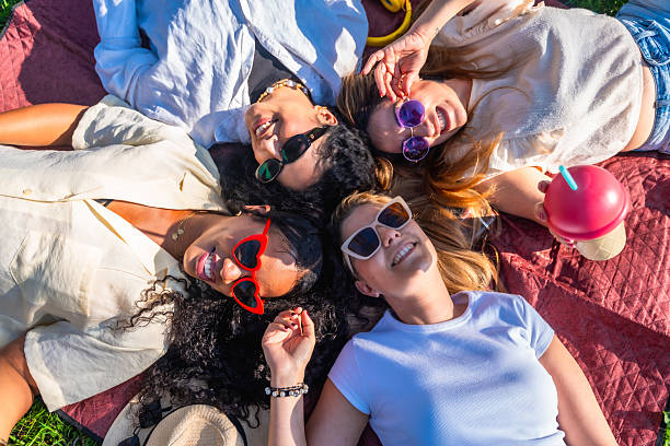 istock Four young women lying on blanket enjoying sunny day 2221649021