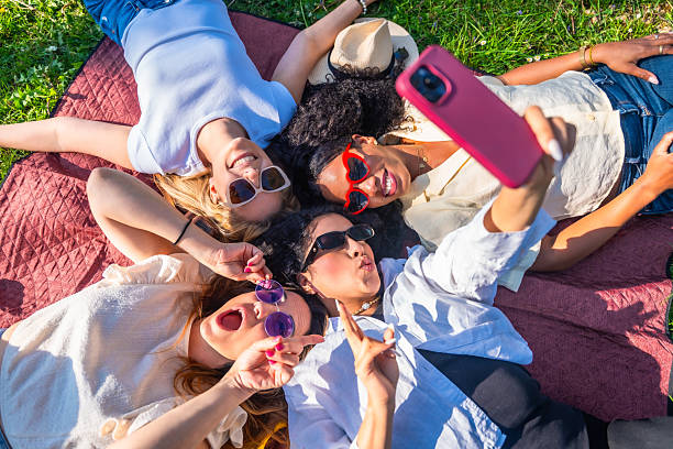istock Four young women taking a selfie lying on a blanket 2221649106