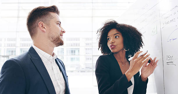 istock Whiteboard, planning or business people in discussion with manager, task or project management. Training, ideas or leader with teamwork for brainstorming for agenda, development or company resources 2221653153
