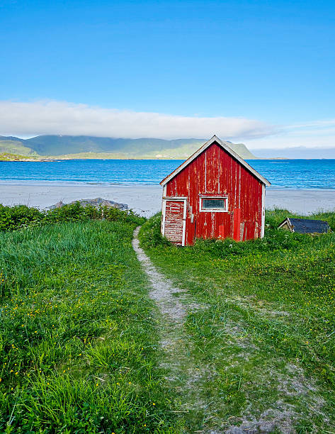 istock Charming red cabin by the serene beach in Norway with stunning coastal views 2221654821