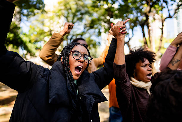 Young woman shouting during protest outdoors