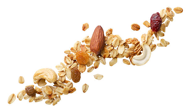 istock Granola muesli with nuts flies close-up on a white. Isolated 2221658404