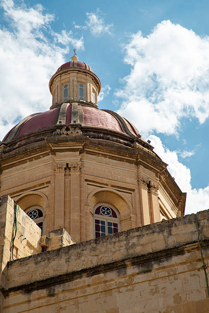 Church Dome Against a Blue Sky with Scattered Clouds – Malta