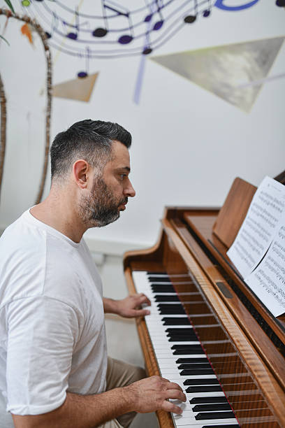 istock Talented Male Pianist Looking Focused And Expressive While Performing Emotionally On Grand Piano 2221663877