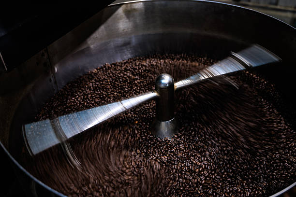 fresh coffee beans roasted spinning cover professional machine to soft focus slow shutter speed want to make motion blur of coffee beans detail, close up
