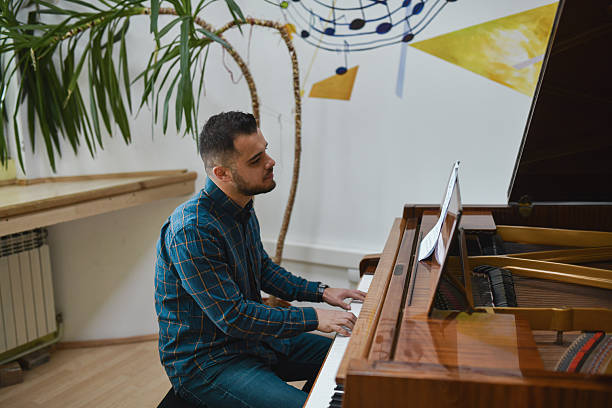 istock Handsome Male Pianist Looking Focused and Passionate While Playing on Piano 2221664043