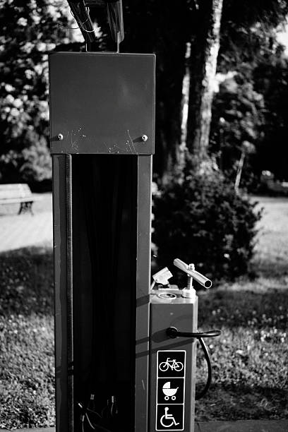 A black and white photograph of a public air and water station, depicting a functional but often overlooked element of public infrastructure.