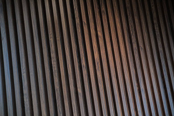 istock Vertical brown wood slats forming a modern decorative paneling texture 2221664410