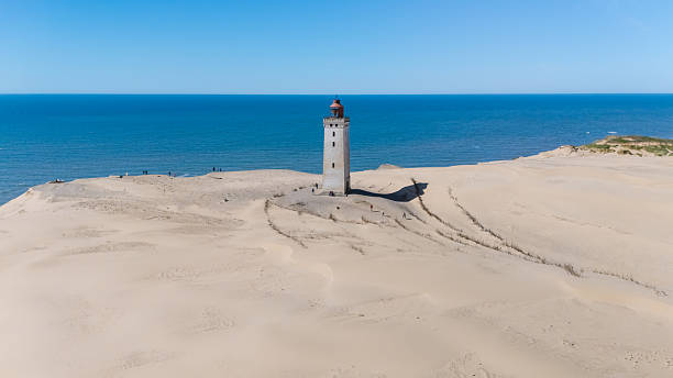 istock Exploring the historic Rubjerg Knude lighthouse standing tall amidst endless sand dunes in Denmark 2221666158