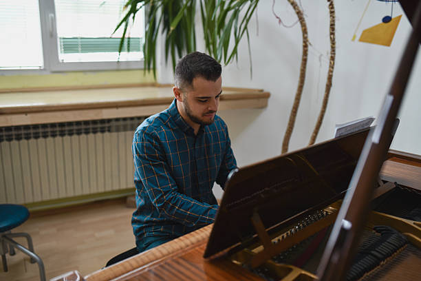 istock Handsome Male Musician Performing On Piano With Focused And Passionate Expression 2221666810