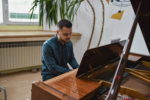 istock Handsome Man Playing Piano With Intense Focus And Emotional Expression 2221666880