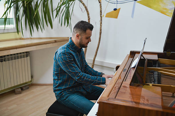 istock Male Pianist Deeply Focused And Passionate While Playing Beautiful Piano Piece 2221666896