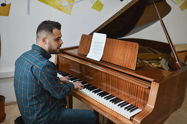 istock Talented Male Pianist Looking Focused And Passionate While Performing On Piano 2221666944