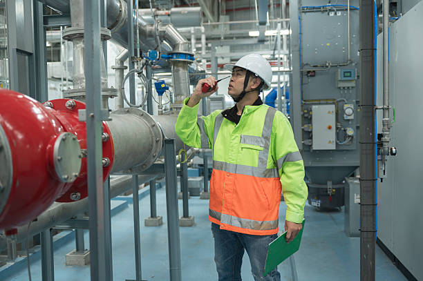 istock Asian Engineer Performing Pipe System Inspection in Modern Industrial Facility. Engineer Monitoring Systems in High-Tech Industrial Facility 2221669413