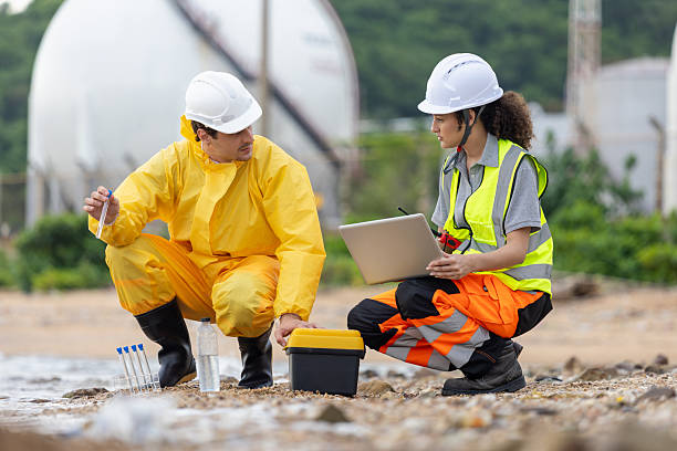 istock Environmental Scientists Collecting Water Samples for Analysis, Team of Engineers Conducting Environmental Impact Assessment, Industrial Pollution Monitoring and Water Quality Testing 2221670992